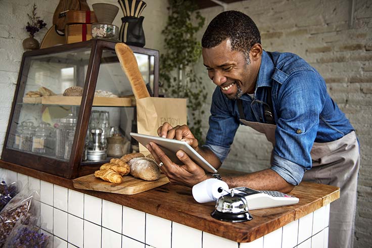 Man reviewing tablet at pastry business